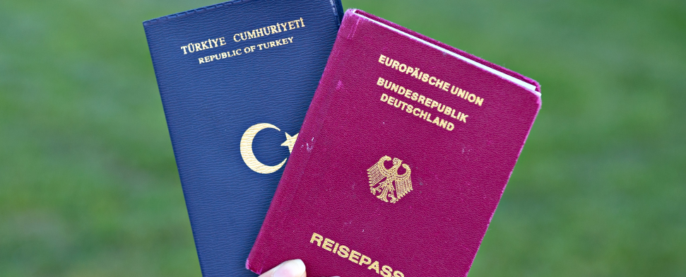 Eine Studentin zeigt am 07.06.2013 in Mannheim (Baden-Württemberg) einen türkischen Pass (l) und einen deutschen Reisepass - dpa
