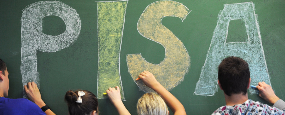 Schüler der neunten Klasse malen in einem Gymnasium in Straubing (Niederbayern) das Wort «PISA» auf eine Tafel - dpa