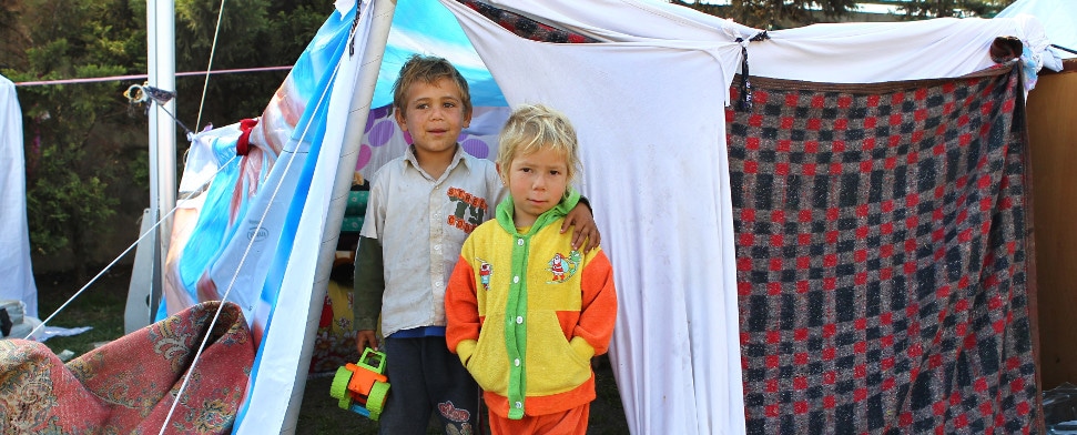 Syrische Flüchtlingskinder vor einem Zelt.