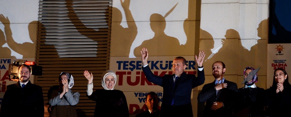 Turkish Prime Minister Recep Tayyip Erdogan (C) cheers to supporters of Turkey's ruling party Justice and Development Party (AKP) with his wife Emine (3rd-L), his daughters Esra Albayrak (2nd-L) and Sumeyye Erdogan (2nd-R), his son Bilal Erdogan (3rd-R) and his son-in-law Berat Albayrak (L) at AKP headquarter after being announced results of local elections in Ankara, Turkey 30 March 2014