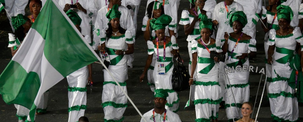 nigeria's flag bearer sinivie boltic holds the national flag as he leads the contingent in the athletes parade during the opening ceremony of the london 2012 olympic games at the olympic stadium july 27, 2012.