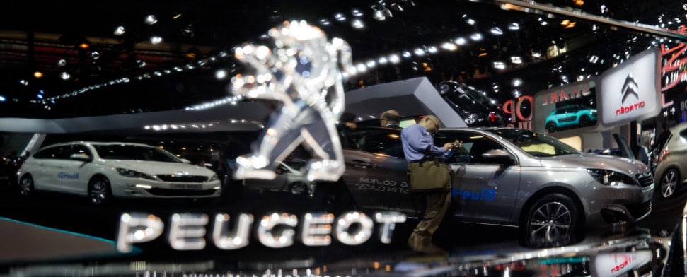 The exhibition area of Peugeot reflects in a car during the second press day of the Paris Motor Show (Mondial de l'Automobile) in Paris, France, 3 October 2014.