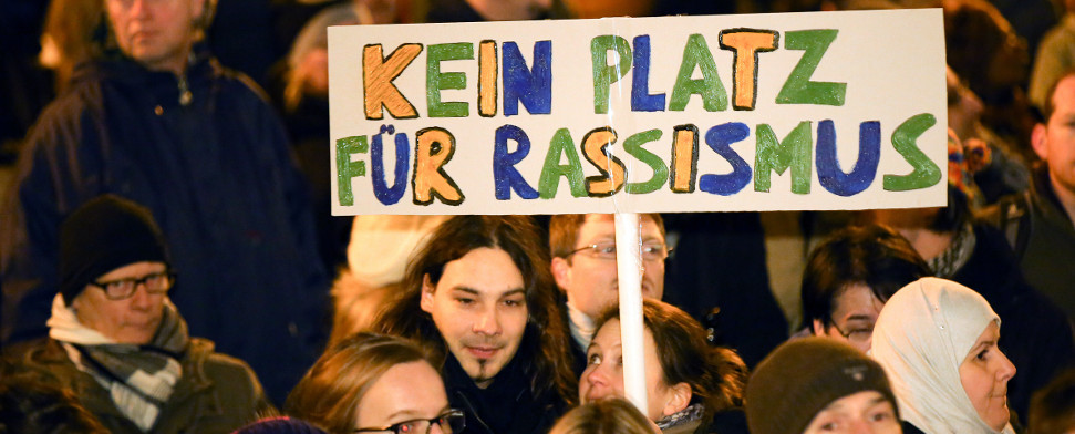 Ein Teilnehmer trägt am 05.01.2015 bei einer Anti-Pegida-Kundgebung in Hamburg ein Schild mit der Aufschrift «Kein Platz für Rassismus». Unter dem Motto «Tolerante Europäer gegen die Idiotisierung des Abendlandes» (Tegida) demonstrierten mehrere tausend Teilnehmer gegen die für den Abend erneut geplanten Demonstrationen der islamkritischen Pegida-Bewegung.